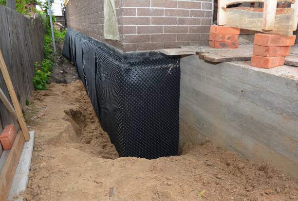 SJ Waterproofing Pros technician performing targeted Wet Basement Repair assessment in Springboro, OH